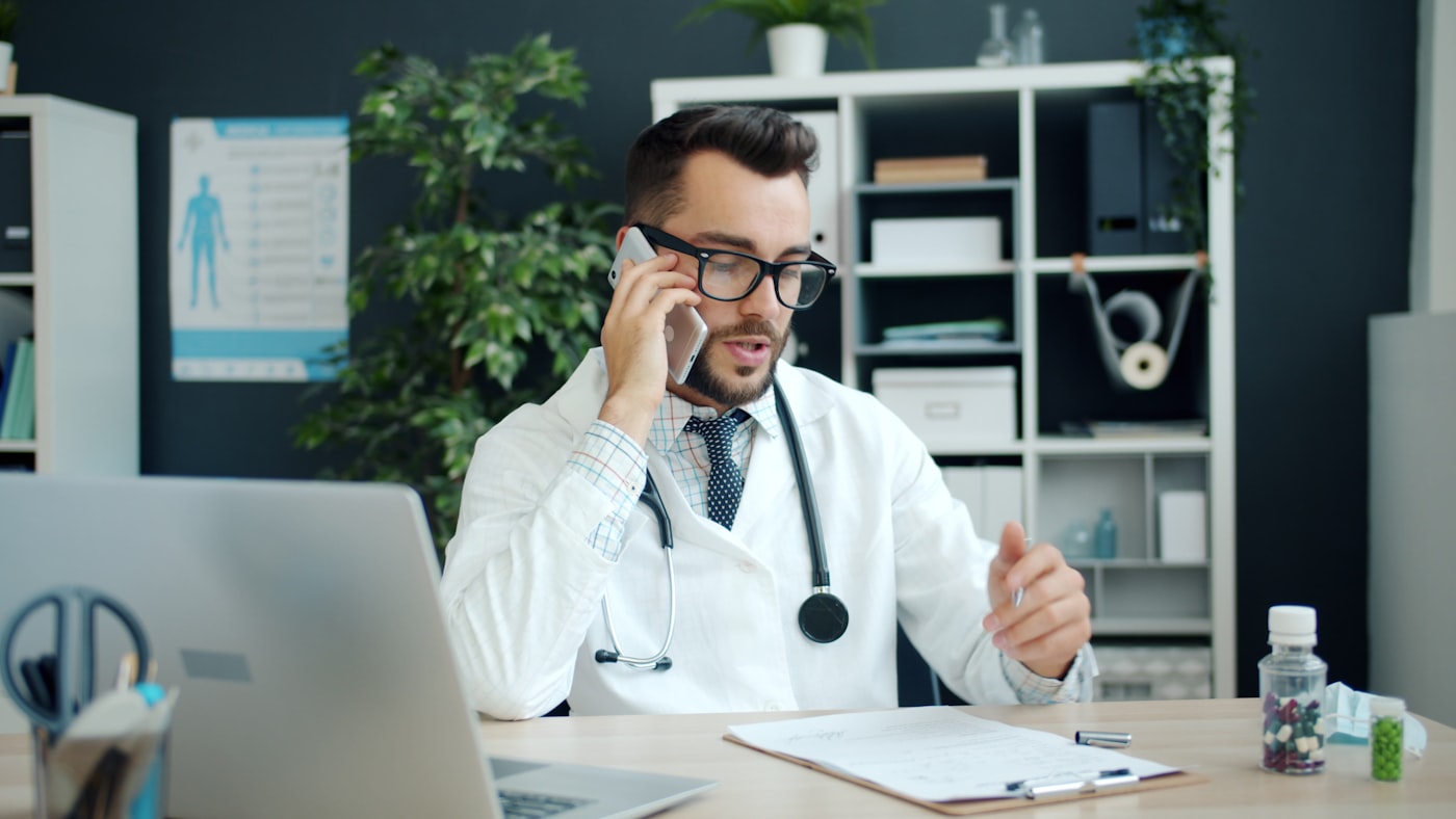 Doctor on the phone at his desk