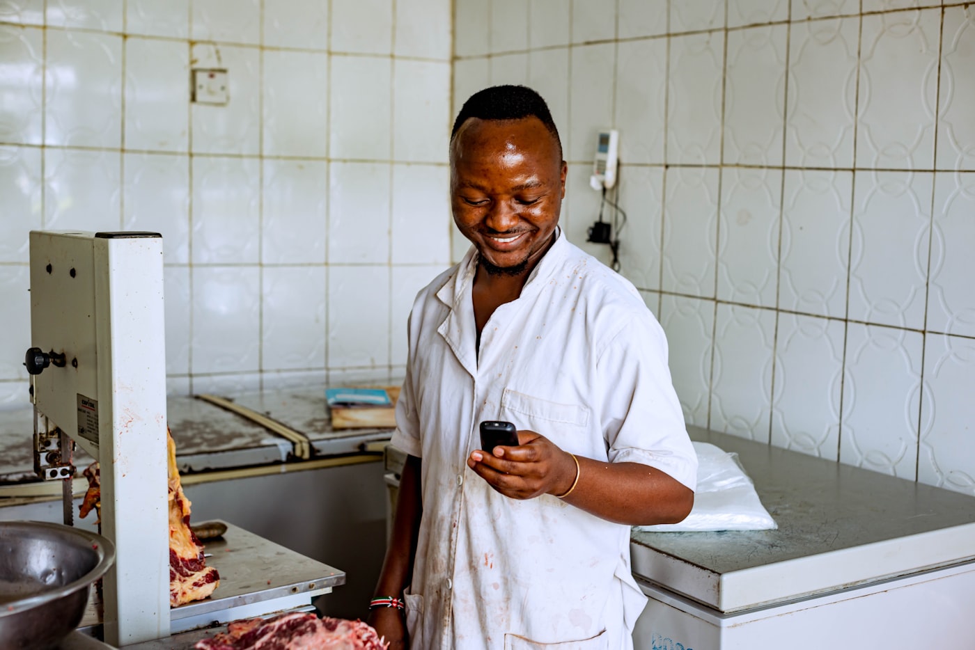 Chef in his kitchen holding a phone